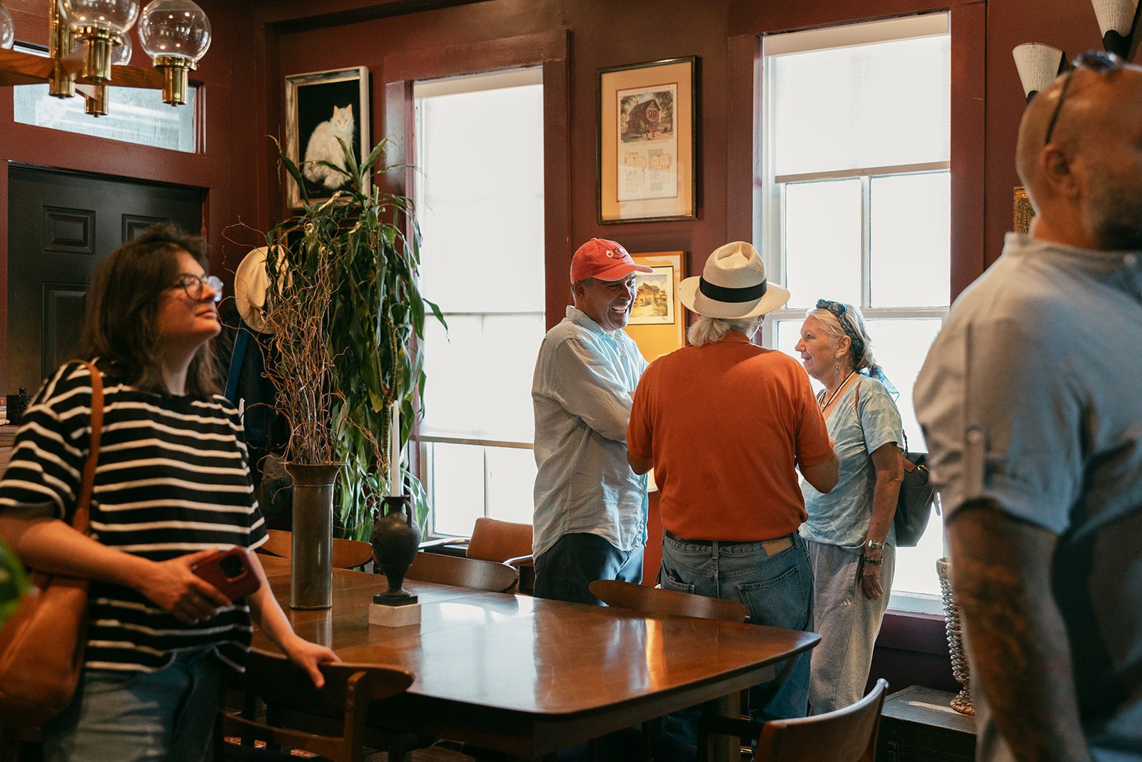 A group of guests gathered around a dining table, talking