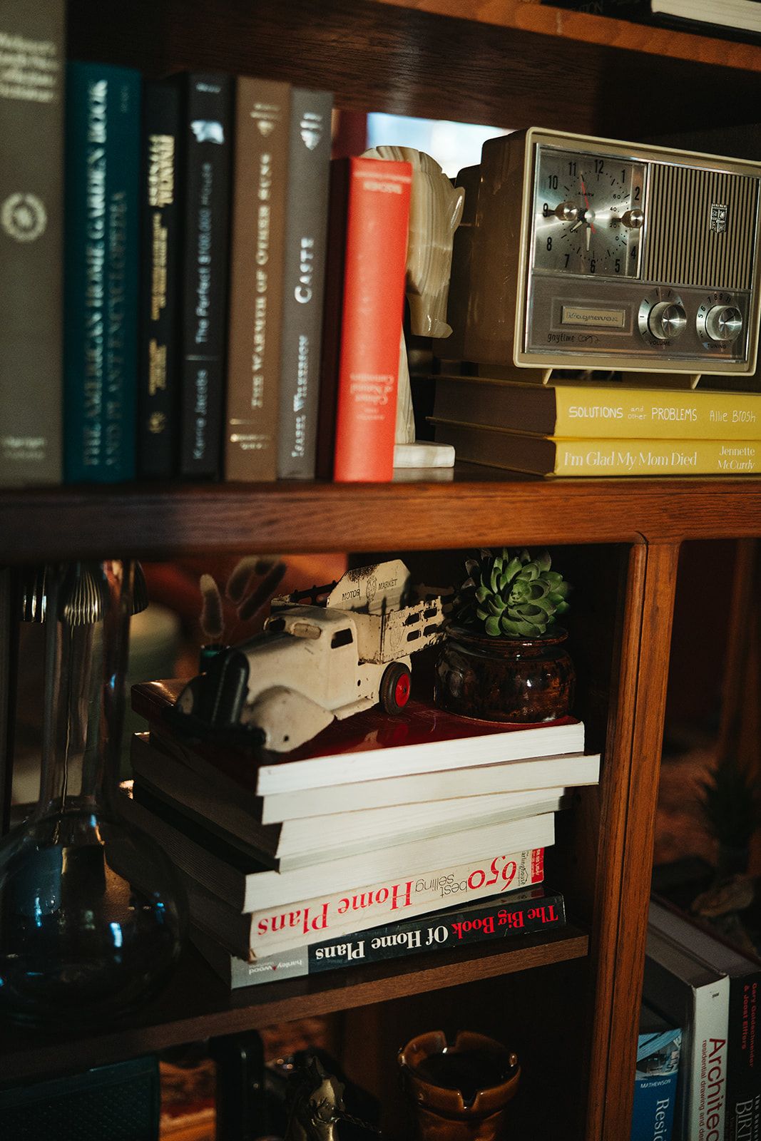 Books stacked beside a vintage camera