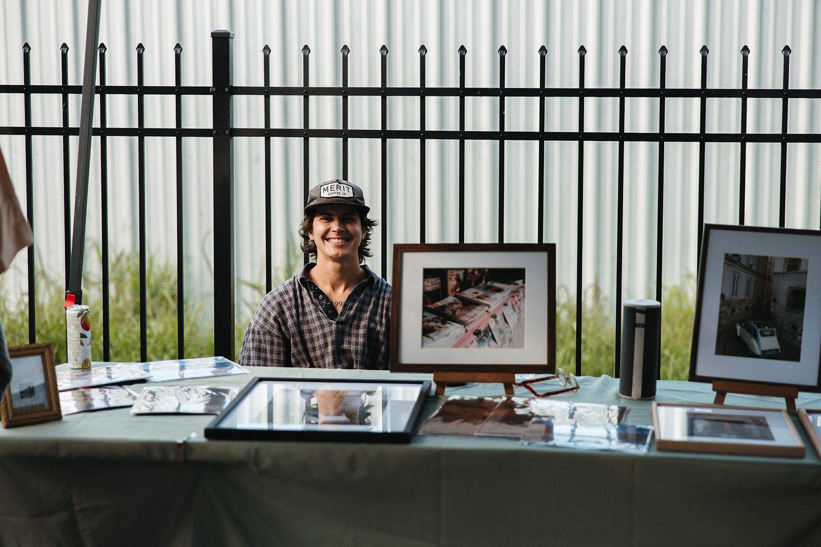 An artist's vendor table with framed prints on display