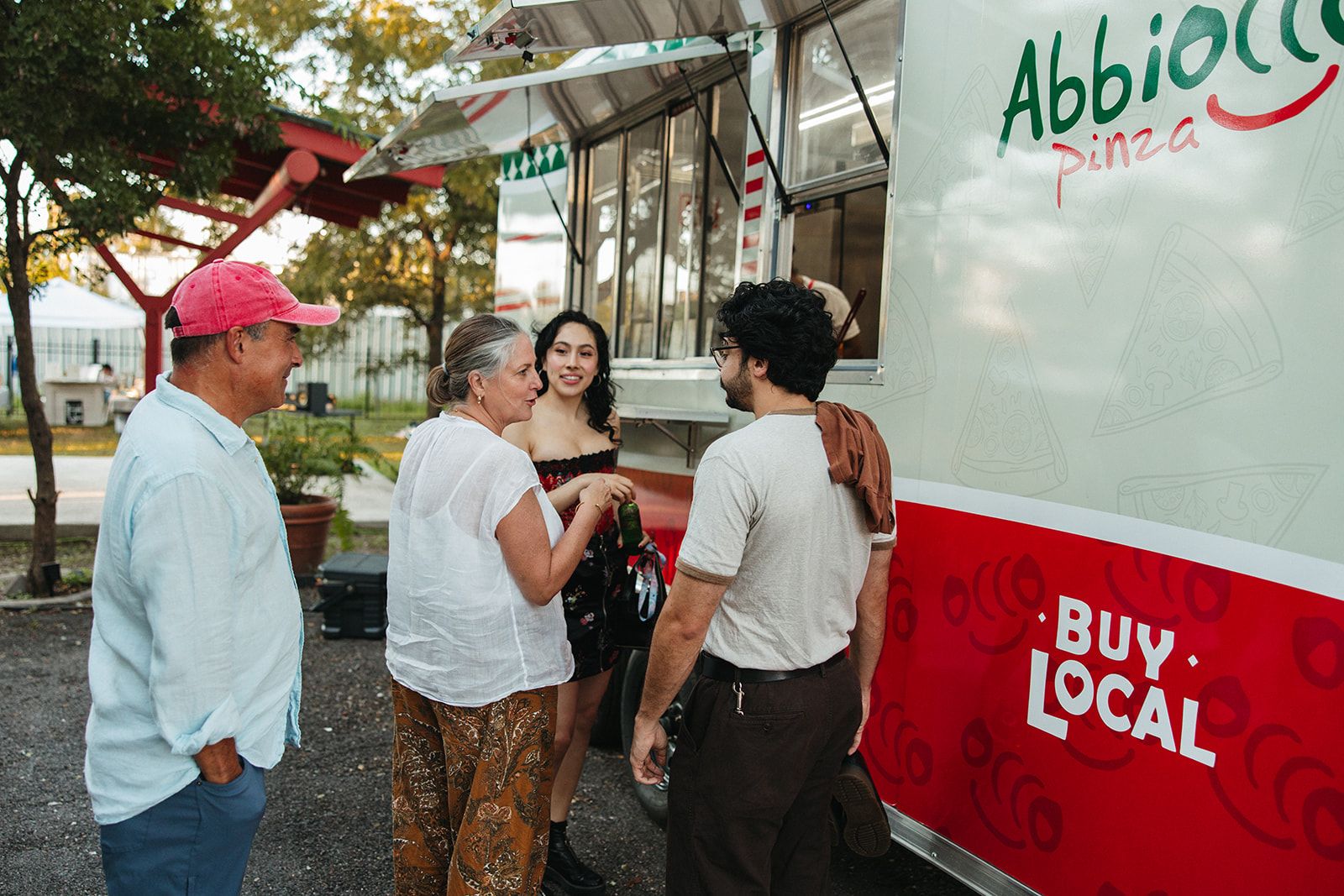 Guests chatting near a pizza truck